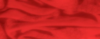 Bulanık, bu kırmızı kumaş pürüzsüz, dalgalı dokusuna odaklanmış, sıcaklığı ve derinliği ortaya çıkarıyor, moda, tasarım ve dekor kavramları için ideal.