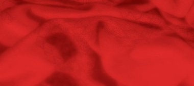 Görüntü, bu canlı kırmızı kumaş kıvrımları ve yumuşak dokusu ile moda, tasarım ve lüks temalar için sıcak ve cezbedici bir arka plan yaratıyor..