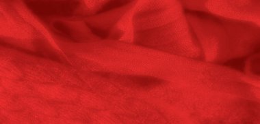 Yumuşak kıvrımlı kırmızı kumaş bulanıklığı derinlik ve hareket hissi yaratıyor. Zengin kırmızı doku sıcaklık ve karmaşıklık ekler, bu da onu tekstil arka planı olarak ideal kılar..