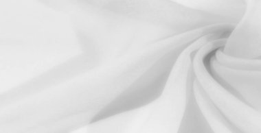 Yumuşak, beyaz bir kumaş üzerinde bulanık bir etki. Yumuşak kıvrımları olan, ince ve ruhani bir dokuyu yakalayan, maddenin ışık ve havadaki özelliklerini yakından vurgulayan..