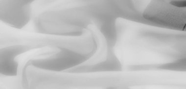 Bulanık minimalist beyaz kumaş yumuşak, nazik kıvrımlar halinde, rafine bir estetik taşıyor. Yumuşak dokusu ve ince kıvrımları, tasarım için ideal, sakin ve lüks bir ortam yaratır..