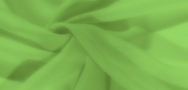 Zarif kıvrımları olan parlak yeşil kumaşlar lüks ve yumuşak bir doku yaratıyor. Akan çizgiler ve pürüzsüz yüzey çeşitli görsel tasarımlar için karmaşık bir arkaplan sunar.
