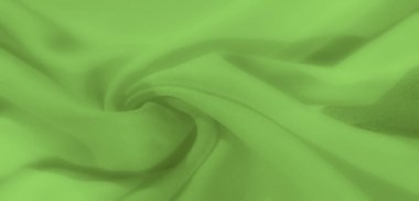Pürüzsüz, yumuşak dalgalarla kıvrılmış canlı yeşil kumaş bulanıklığı. Kumaşlar katmanlı dokular ve sakin yeşil gölgeler yumuşak ve organik bir etki yaratıyor.