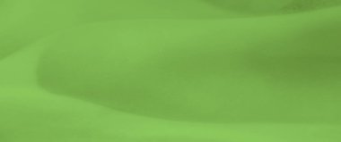 Yumuşak kıvrımlı canlı yeşil kumaşın bulanık etkisi. Kusursuz tasarım doğal olarak akar, arka plan ya da tekstil deseni için ideal ama pürüzsüz bir yüzey sunar..
