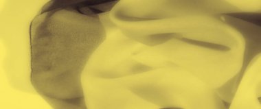 Sarı kumaş üzerindeki bulanık etki yumuşak kıvrımlarını ve akış çizgilerini artırarak soyut bir kompozisyon oluşturur. Kibar kıvrımlar sükunet ve görsel çekicilik hissi verir..