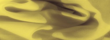 Görüntü hassas sarı kumaşı gösteriyor, kıvrımları yumuşak katmanlar halinde katlıyor. Gölgeler yumuşak bir derinlik ekler, kumaşı desenli ve çeşitli tasarım kullanımları için davetkar gösterir..