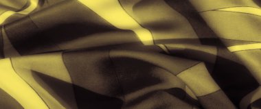 Pürüzsüz altın dalgaların bulanıklığı, soyut şekillerin dinamik akışını vurgulayan kumaş üzerindeki koyu tonlarla çelişiyordu. Karmaşık kıvrımlar bu lüks tekstilde derinlik ve görsel ilgi yaratıyor..