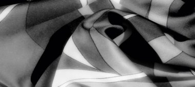 Görüntü. Katmanlı katmanlı ve aydınlıktan karanlığa gradyanlarla gri ölçekli minimalist kumaş zarafet ve derinlik saçan ince bir doku sergiliyor..