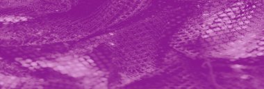Pırıl pırıl parıldayan mor dantel kumaşın bulanık görüntüsü. Hassas dokusunu ve karmaşık yapısını vurgulayarak sofistike bir görsel etki yaratıyor..