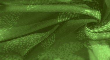 Yumuşak kıvrımları ve doğal motifleri olan yeşil kumaşın üzerindeki bulanık etki huzur verici bir zemin oluşturur. İnce yaprak benzeri desenler, tekstil yüzeyine organik ilgi ekliyor..