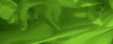 Yumuşak ve pürüzsüz yeşil kumaştan ince kıvrımlar ve karmaşık dokular, soyut tasarımlar veya arka planlar için canlı bir renk ve hassas bir akış sergiliyor..