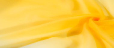 Pürüzsüz, yumuşak kıvrımlı sarı bir kumaş, yumuşak ve davetkar bir doku. Kumaşın sıcak rengi ve dingin görünümü dekoratif ve tasarım amaçlı kullanılmasını sağlar..