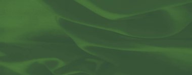 Pürüzsüz bir dokusu ve zarif kıvrımları olan zümrüt yeşili kumaşın bulanıklığı yumuşak maddesini ve doğal derinliğini vurguluyor. Tekstil ya da sanatsal altyapı için harika.