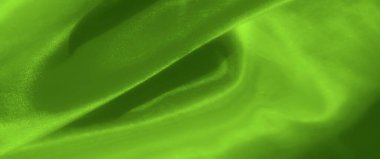 Katmanlı kıvrımları ve yumuşak dokuları olan zengin yeşil kumaş bulanıklığı soyut ve canlı bir tasarım yaratıyor. Yumuşak ayrıntılar rahatlatıcı ve sanatsal bir hissi çağrıştırıyor..