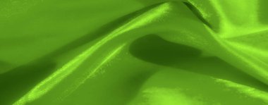 Bulanık yeşil kumaş dalgaları nazik kıvrımlar ve soyut dokular oluşturur, ışık ve hareketin barışçıl özünü yayar, modern tasarım estetiği için mükemmeldir..