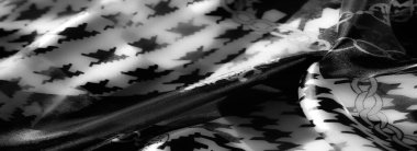 Gri ölçekli kumaş görüntüsü yumuşak kıvrımlı karmaşık geometrik desenleri vurgular, sanatsal sunumlar için dinamik bir ışık ve doku oyunu yaratır.