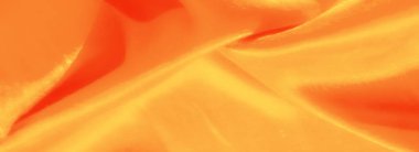 Parlak turuncu saten kumaş, akışkan, yansıtıcı dokular. Lüks ve parlak bir efekt yakalıyor. Yaratıcı arka planlar ve tasarımlar için mükemmel..