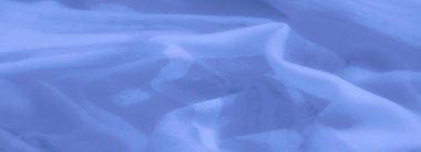 Yumuşak dokuları ve dinamik akış şekilleri olan soyut mavi kumaş bulanıklığı, yaratıcı tasarımlar ve sakinleştirici arka planlarda kullanmak için zarafet ve basitliği birleştirmek