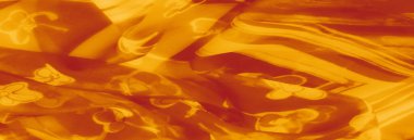 Görüntü. Çiçek desenleri ve kalın dokuların eşsiz bir kombinasyonuna sahip turuncu bir kumaşın detaylı bir görüntüsü, yaratıcı projeler için göz alıcı görsel estetik sunuyor..