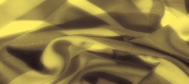 Görüntü bu soyut sarı ve siyah kumaş desenindeki zarif akışı vurguluyor. Kumaşın pürüzsüz dokusu nazik kıvrımlarla birleşince modern ve sofistike bir görünüme bürünüyor..