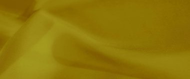 Akan, yumuşak kıvrımları ve ipeksi dokusu olan parlak, altın sarısı kumaştan bir bulanıklık. Tekstil yüzeyi zarif gölgeler ve röfleler sergiliyor, hassas bir parıltı yaratıyor..