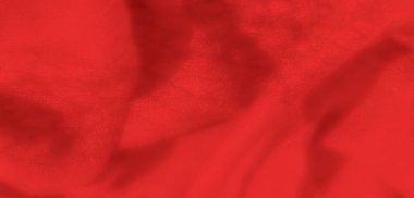 Görüntü, dokusu kıvrımlı kırmızı bir kumaş lüks ve sofistike bir estetik yaratıyor, arka plan tasarımları ve moda odaklı görseller için mükemmel..