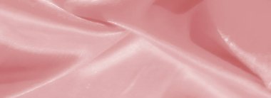 Görüntü. Pürüzsüz kıvrımları ve ışıl ışıl parıltısı olan canlı pembe bir kumaş. Moda, dekor veya yaratıcı projeler için mükemmel ipek ve lüks dokusunu sergiliyor..