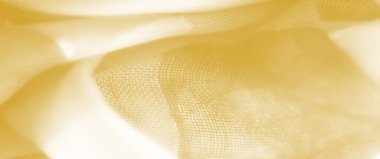 Yumuşak dalgalarda bulanık sarı kumaş, şeffaf ve parlak bir kaplama, parlak ve davetkar bir doku yaratıyor..