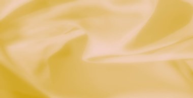 Yumuşak, akışkan bir dokusu ve zarif kıvrımları olan sarı kumaş bulanıklığı tasarım ve dekoratif amaçlar için sofistike ve sanatsal bir zemin oluşturuyor..