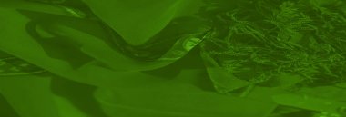 Bulanık yeşil tekstil soyut çiçek desenleri ve ışıltılı renklerle süslenmiş zarif dekorlar ve moda eserleri için zarif ve canlı bir görünüm yaratıyor..