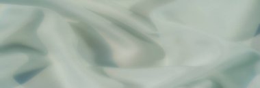 Pürüzsüz kıvrımları ve hafif bir dokusu olan, görsellik ve tasarım kullanımı için mükemmel minimalizm ve sofistike bir hava yaratan, huzurlu, pastel yeşil kumaşın bulanıklığı..