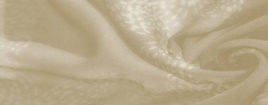 Yumuşak kıvrımlı bej kumaş bulanıklığı ve zarif çiçeklerden esinlenilmiş motifler, zarif dekorasyon ve tekstil tasarımları için mükemmel olan havadar ve yumuşak bir doku içeriyor..