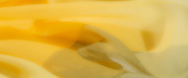 Girdap desenli yumuşak sarı kumaş ve sıcak, davetkar tonlar. Yumuşak, narin kıvrımlar dekoratif ve arka plan amaçları için mükemmel bir estetik sağlar.