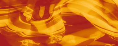 Kaprisli çiçek desenli saydam turuncu kumaş bulanıklığı. Kumaş etkileşiminin katmanları büyüleyici ve ruhani bir etki yaratıyor..