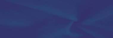 Yumuşak kıvrımları ve karmaşık dokusu olan bulanık mavi kumaş zarif tasarımlar ve yaratıcı görsel projeler için lüks ve rahatlatıcı bir estetik sunuyor..