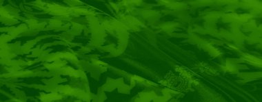 Bulanık, yeşil tekstil. Karmaşık zincir motifleri ve keskin houndstooth desenleri sergiliyor. Yumuşak kıvrımlı zarafet yayıyor..