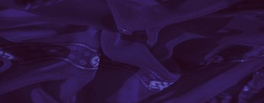 Bulanık, çiçekli ve geometrik desenli karmaşık bir mor kumaş. Hassas detaylar ve parlak aksanlarla vurgulanmış. Zarafet ve incelik hissi yaratıyor..