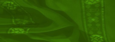 Pürüzsüz, dalgalı yeşil kumaştan oluşan bir bulanıklık parıldayan aksanlar ve zarif desenler, her kıvrımda bir tarz ve incelik hissi yayıyor..