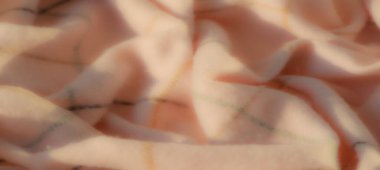 Narin kıvrımları ve pürüzsüz dokusu olan yumuşak beyaz bir kumaşın bulanık detayları. Kumaşlar doğal ışık ve ince desenler dekorasyon için ideal minimalizm ve incelik katar.