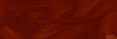 Görüntü. İnce desenleri ve zarif kıvrımları olan pürüzsüz kırmızı bir kumaş. Sıcak tonlar ve karmaşık detaylar yaratıcı projeler için gelişmiş bir tekstil ideali yaratır..