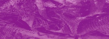 Canlı mor dantelli kumaş karmaşık desenler ve hassas dokular sergiliyor, büyüleyici bir ışık ve gölge karışımı yaratıyor. Tekstil ve tasarım için ideal..