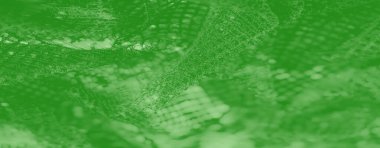 Zarif yeşil örgü kumaşın parıldayan ipliklerle bulanık, dekoratif ve tekstil projeleri için mükemmel güzel ve karmaşık bir tasarım sergiliyor..