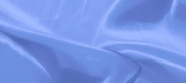Hafif kıvrımlı, bulanık mavi kumaş ve ışık yansımaları, zarafet ve incelik yayıyor. Özgeçmiş, tasarım veya lüks temalar için ideal.