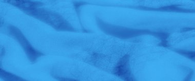 Yakın plan mavi kumaş bulanıklığı, ince doku ve nazik kıvrımlar sergiliyor. Yumuşak dalgalar ve yumuşak, zengin renkler sakinleştirici ve zarif bir etki yaratır.,