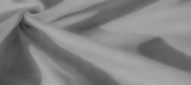 Görüntü. Yumuşak ışıklandırma ve hassas dokuyla dinamik kıvrımlar modern tasarım ve fotoğrafçılık için mükemmel bir rafine kompozisyon oluşturur..