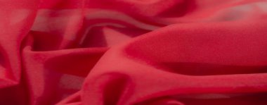 Görüntü: İnce desenli kırmızı kumaşın karmaşık kıvrımları arka plan veya tekstil odaklı projeler için mükemmel zarif ve minimalist bir tasarım oluşturur.