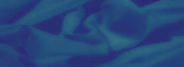 Dinamik kıvrımları ve gradyanı olan soyut mavi kumaş bulanıklığı. Işık ve gölge etkileşimi akıcılığını arttırarak modern ve minimal bir estetik yaratıyor..