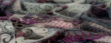 Dinamik kumaş tasarımının bulanıklığı, koyu siyah-beyaz desenleri çarpıcı mor ve kırmızı aksanlarla birleştirmek, zarif kıvrımlar ve karmaşık dokular..