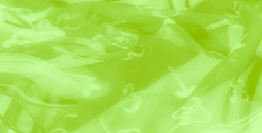 Bulanık, ilginç çiçek aksanları, yumuşak dokuları olan canlı yeşil bir kumaş ve modern moda ya da ev dekorasyonu projeleri için uygun sofistike yayılan kıvrımlar..