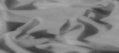 Dinamik kıvrımlı bulanık gri pullu kumaş, yaratıcı uygulamalarda çok yönlü modern bir estetiği vurgulayarak, akıcı ve soyut bir tasarım yaratıyor..